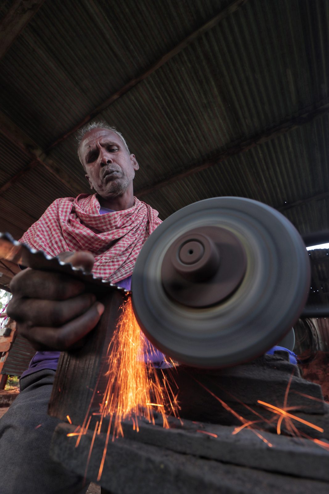 A blacksmith at work amid sparks
